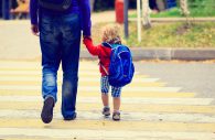 Stock photo: Father walking little daughter with backpack to school or daycare.