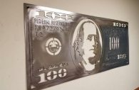 Ben Franklin on the $100 bill done in metal art.