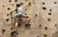 A Young Woman Climbing a Wall --- Image by © Corbis (Fotolia)